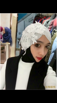 white scarf adorned with some beautiful ornaments