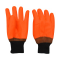 Fluoreszierende orange PVC-beschichtete Handschuhe sandig