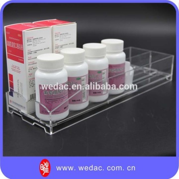 Healthcare products drugstore vitamin bottles shelf pusher