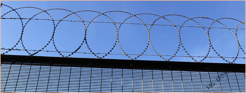 High security 358 Clearvu fence with top-mounted razor barbed wire