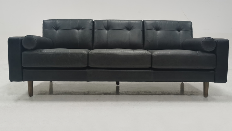 Light colored leather three person sofa