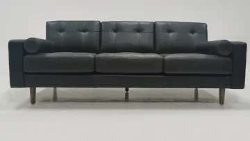 Light colored leather three person sofa