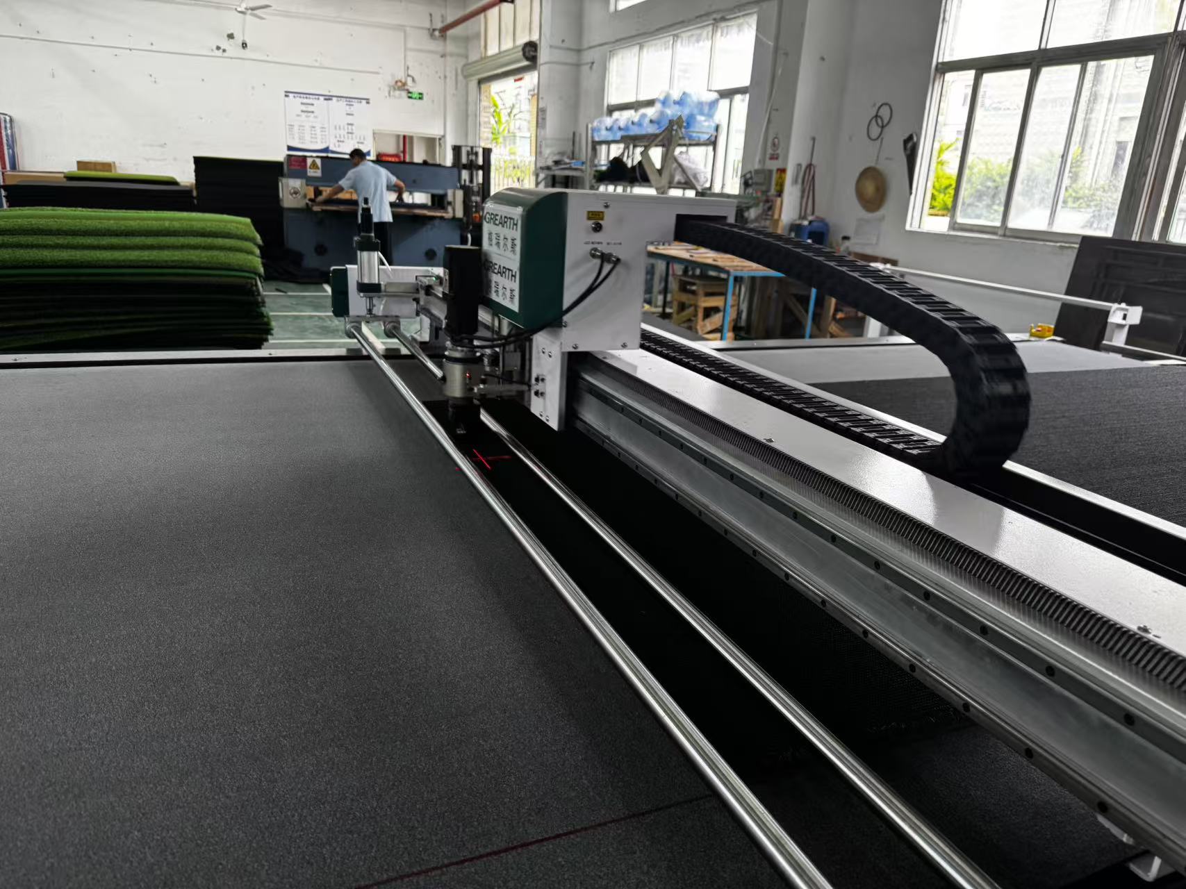 Digital turf cutting machine cutting artificial turf for custom golf mats