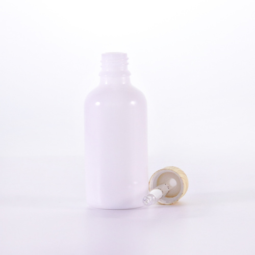 Botella de aceite esencial blanco con gotero de textura de bambú
