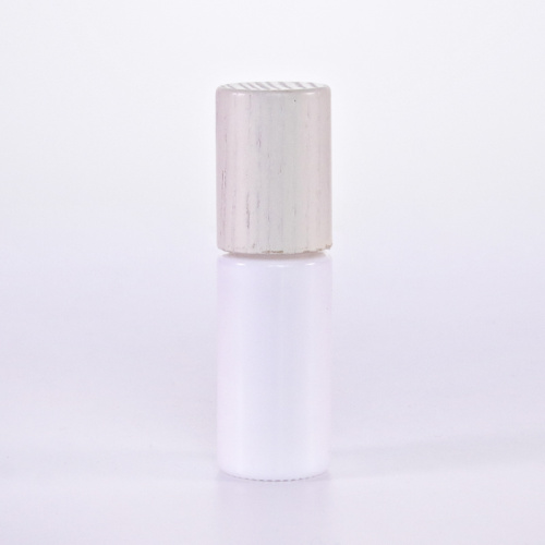 White glass roll on bottle with wooden lid