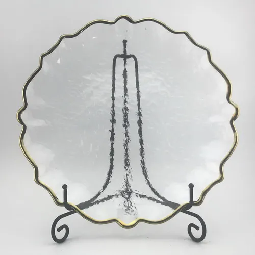 Clear glass plate dinner with gold rim.