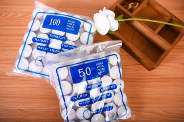 White tealight candles in plastic bag​