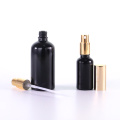 Black glass bottle with golden aluminium caps