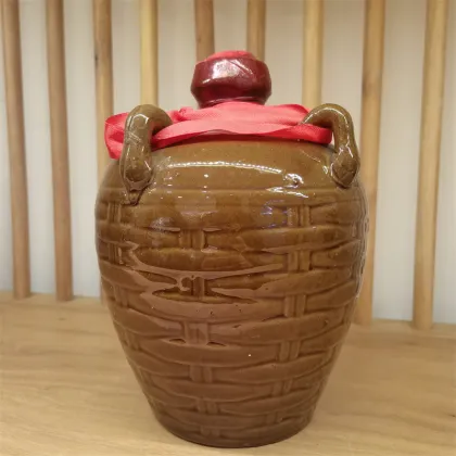 Yellow porcelain jar filled with yellow wine