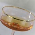 hand blown champagne saucer glass with gold rim