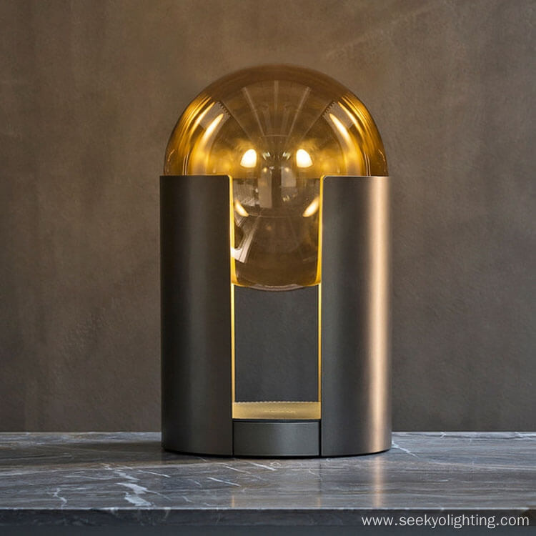 Metal cylindrical base supports glass ball desk lamp