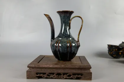 Two sets of hand holding teapot and tea set