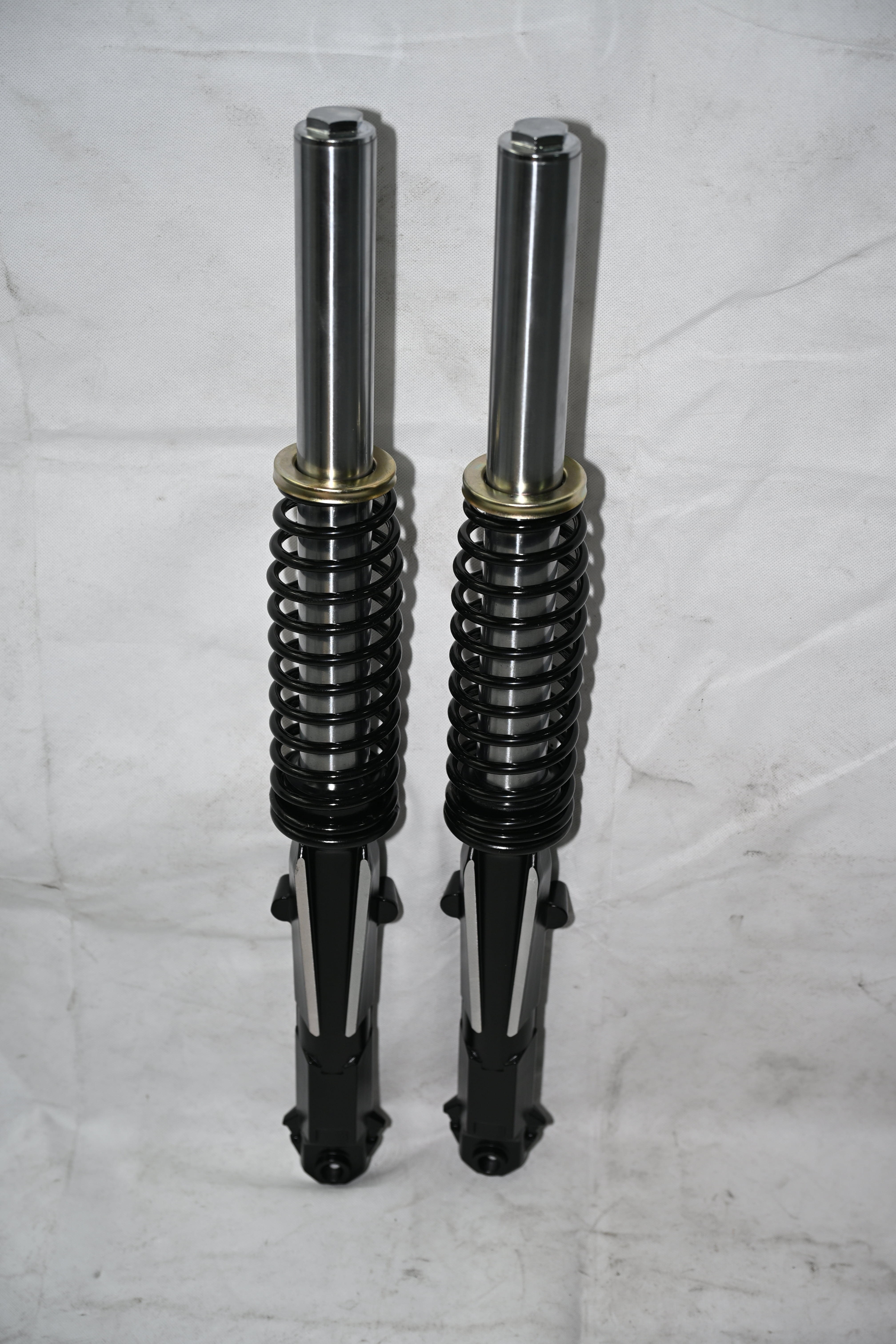 External spring tip shock absorber