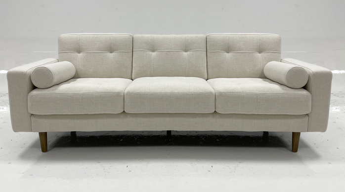 Light colored fabric three person sofa