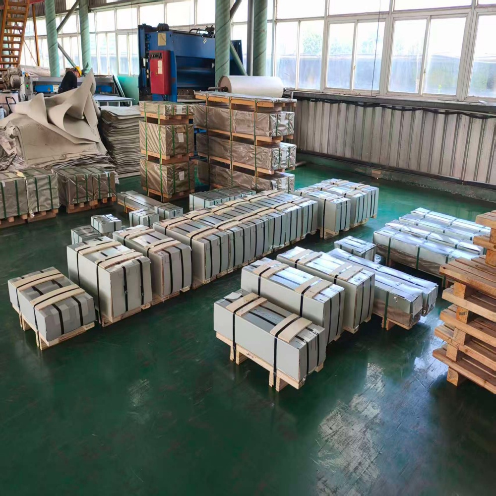 Packaged galvanized steel coils in warehouse.