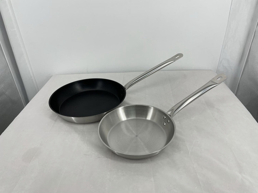 An uncoated metal frying pan