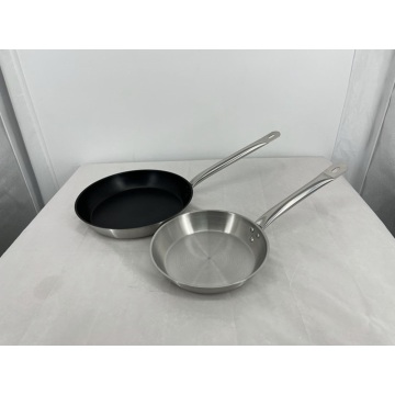 An uncoated metal frying pan