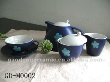 glazed ceramic tea cup and saucer with flower