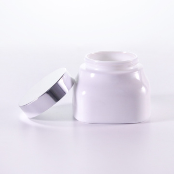 Square white glass cream jar with silver cap