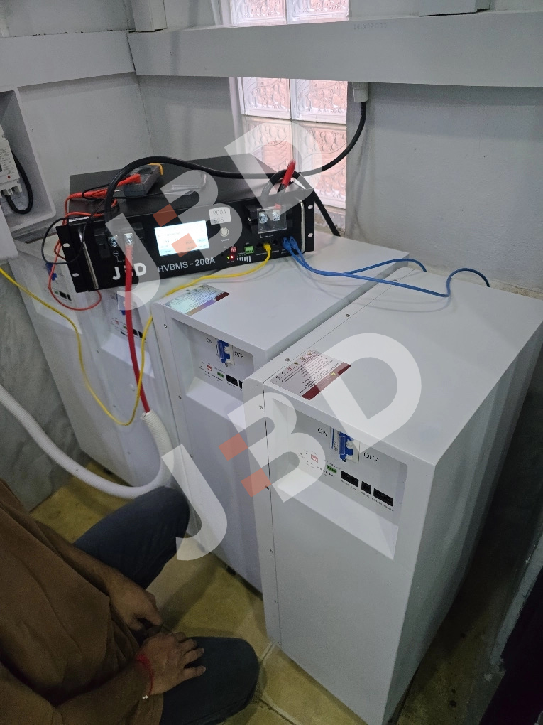 JBD HVBMS-200A High Voltage Master Controller unit connected to residential LiFePO4 battery rack with CANbus communication cables