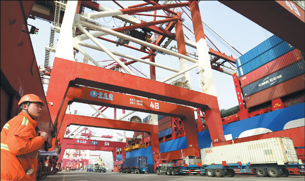 An employee oversees loading of cargo bound for the United States at Qingdao Port in Shandong province