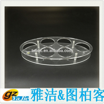 Elegant oval acrylic display holder for small cup .