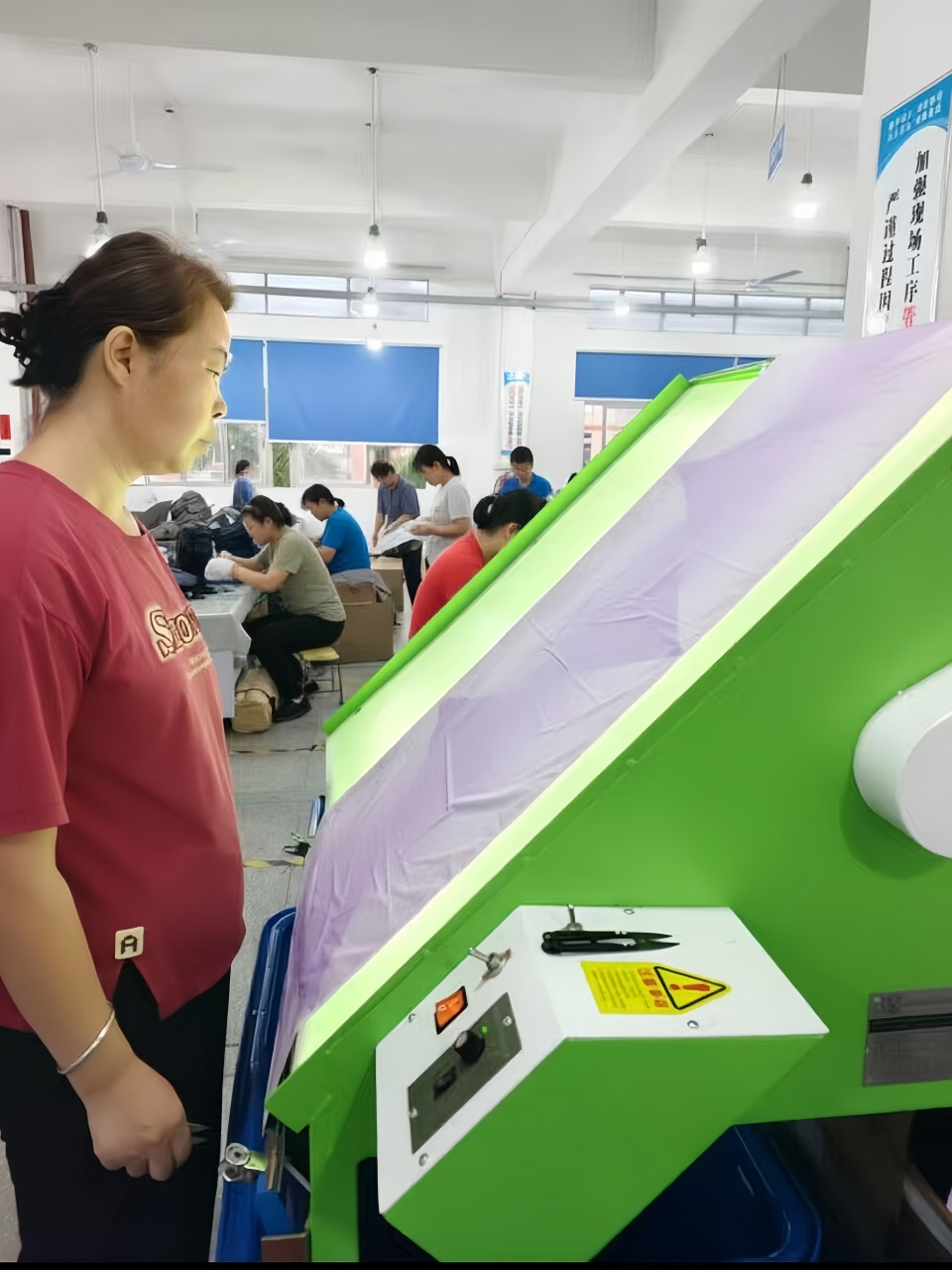 Worker-operating-fabric-inspection-machine-umbrella-quality-check