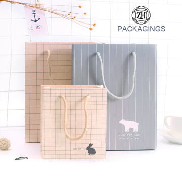 Sacchetto di carta regalo con manici in colore chiaro