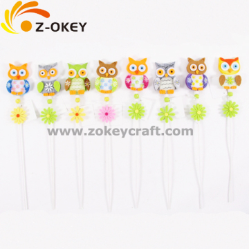 Different colorful owl felt crafts with a stick for home decoration