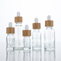 Botellas de gotero de vidrio transparente contenedor cosmético de tapa de bambú