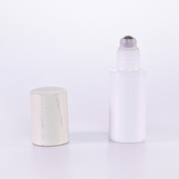 White glass roll on bottle with wooden lid