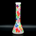 A glass water pipe with a colorful mushroom pattern