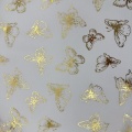 Tessuto tulle in poliestere con lamina di farfalle dorate