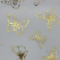Tessuto tulle in poliestere con lamina di farfalle dorate