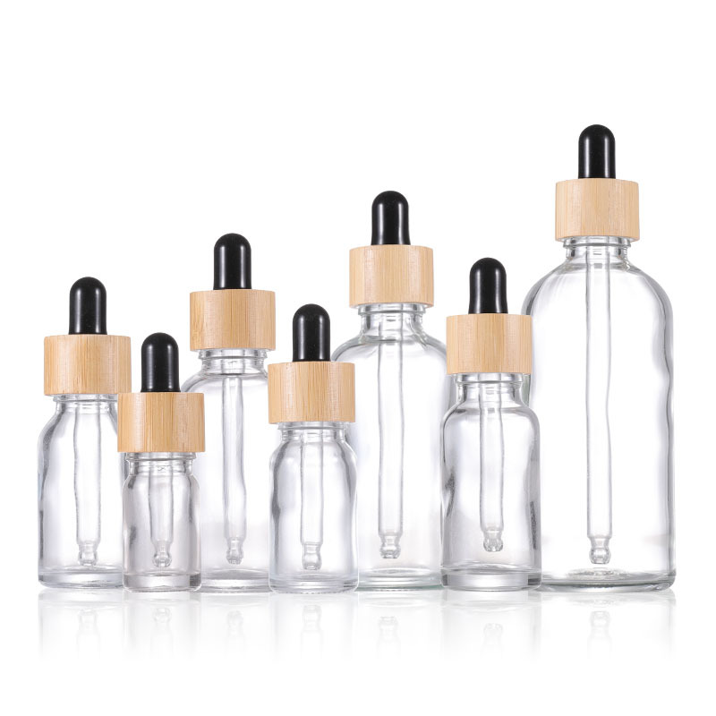 Botellas de gotero de vidrio transparente contenedor cosmético de tapa de bambú