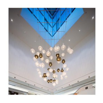 Large Atmospheric Indoor Lobby with Handmade Artistic Glass Chandeliers