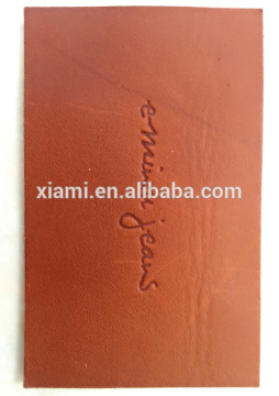 simple style debossed words orange top layer jeans leather label design