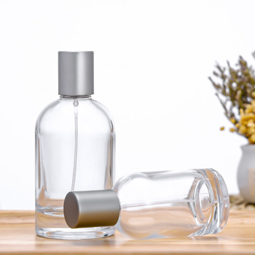 Botella de perfume de vidrio transparente con tapa de aerosol de la bomba