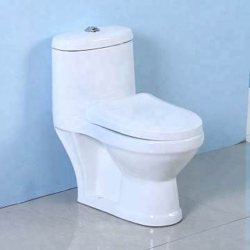Preschool Boy Squatting to Use Urinal in Kindergarten Bathroom