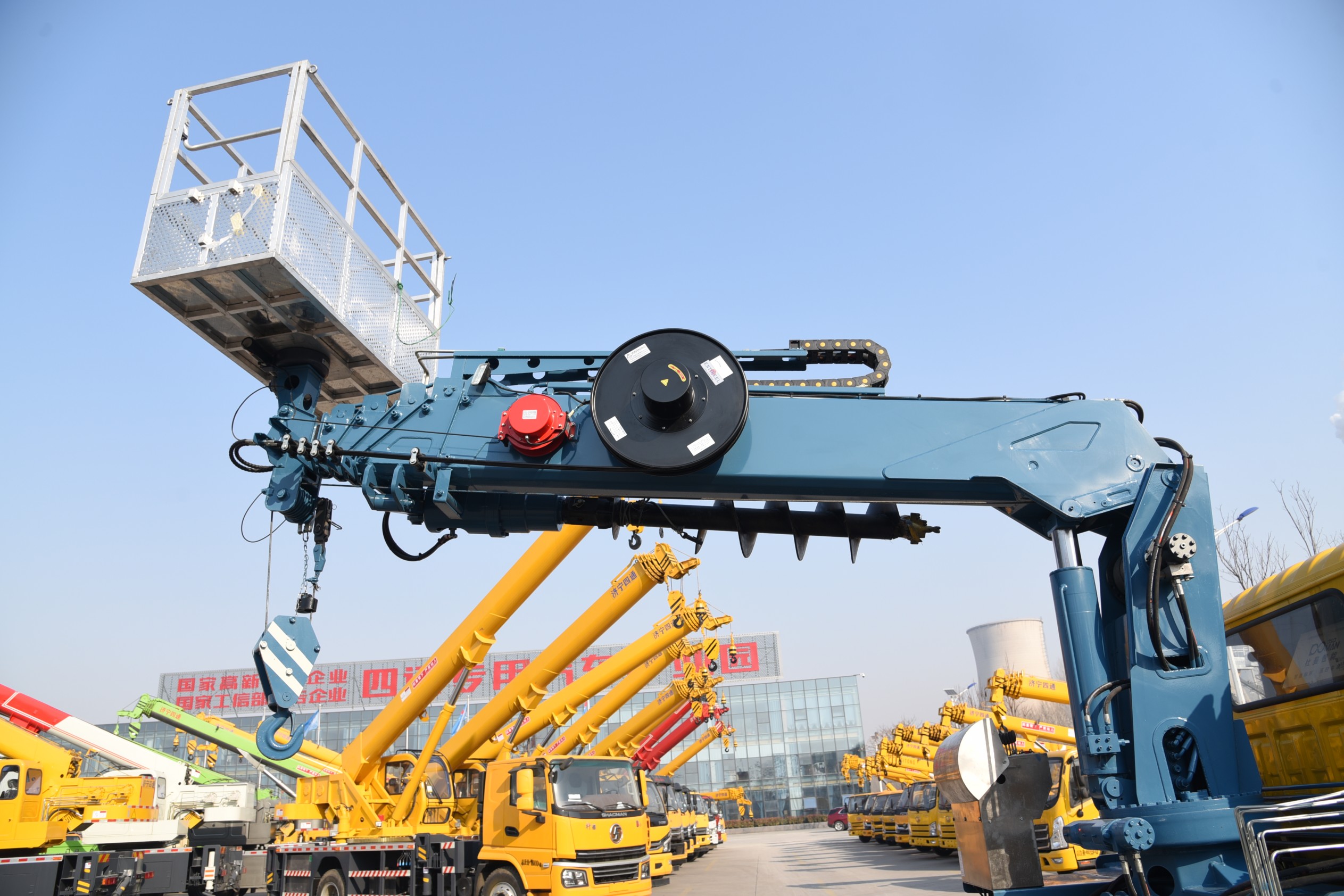 Multi-functional truck-mounted crane with drill bit