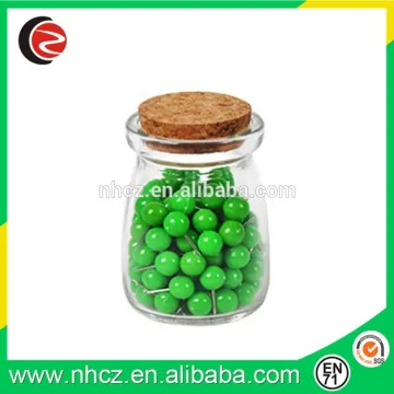 Green Round push pin in glass bottle