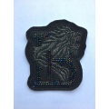 Bead embroidered garment embroidered with glue patch