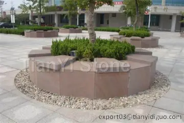 Red sandstone tree pit surrounds curbstone