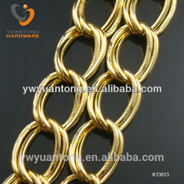 gold color double chain with straight line surface