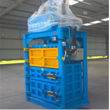 Waste paperboard baler machine