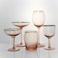 pink colored wine glass set with gold rim