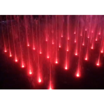 Fontaine d'eau au sol avec lumières