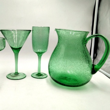 green glass carafe champagne coupe flute with bubble