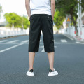Pantalones cortos deportivos de PVC de color puro para hombre con cintura elástica