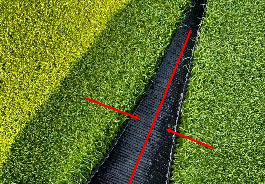 Both sides of the synthetic golf green turf have been trimmed and prepared for joining